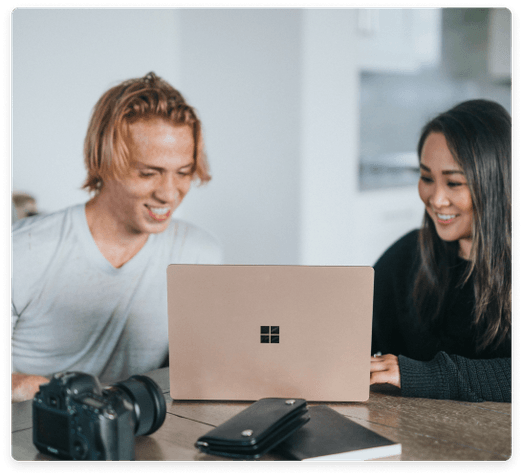 two microsoft buddies working on laptop