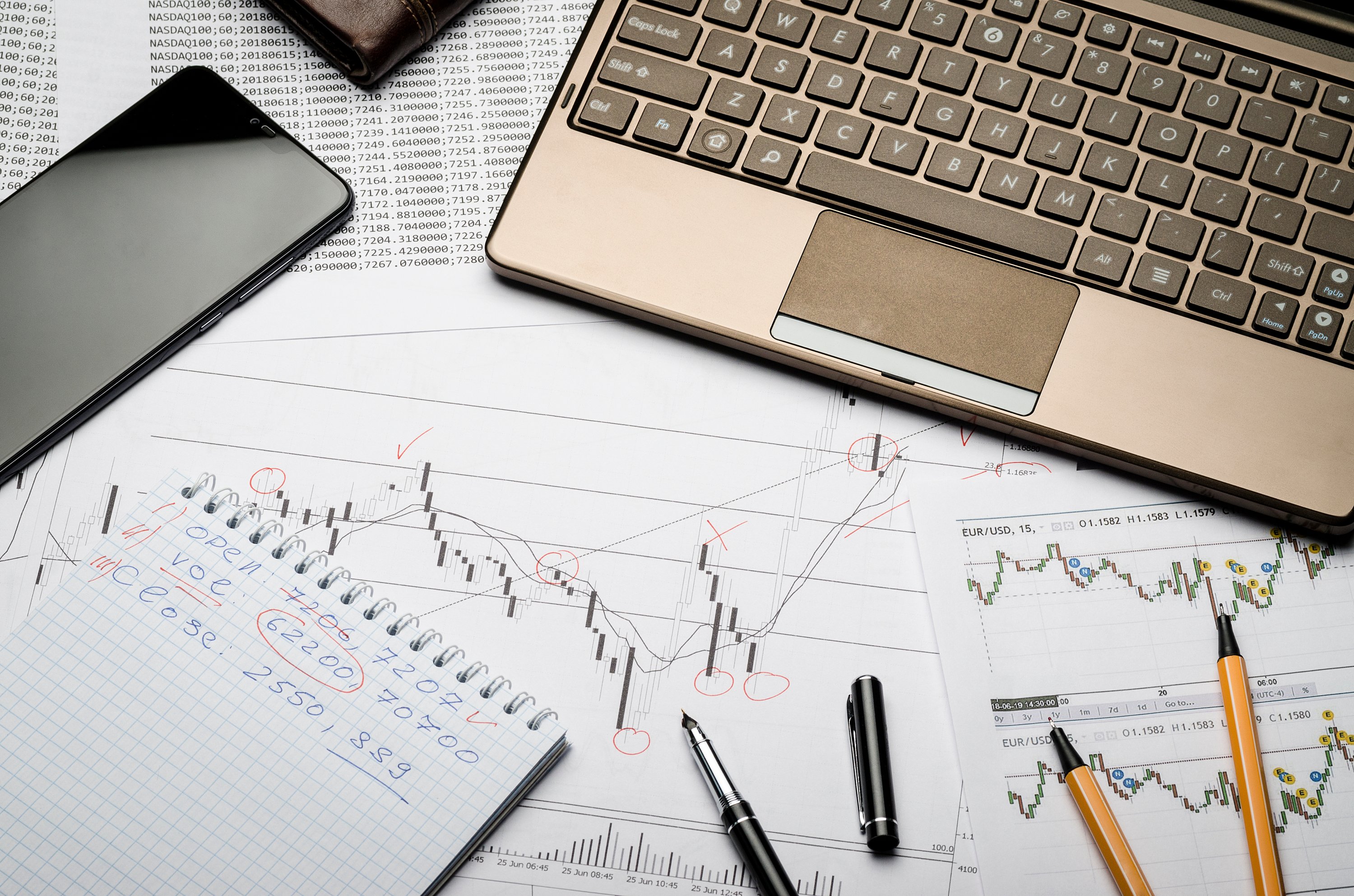 Amazon product stats and figures on a desk with a laptop and phone